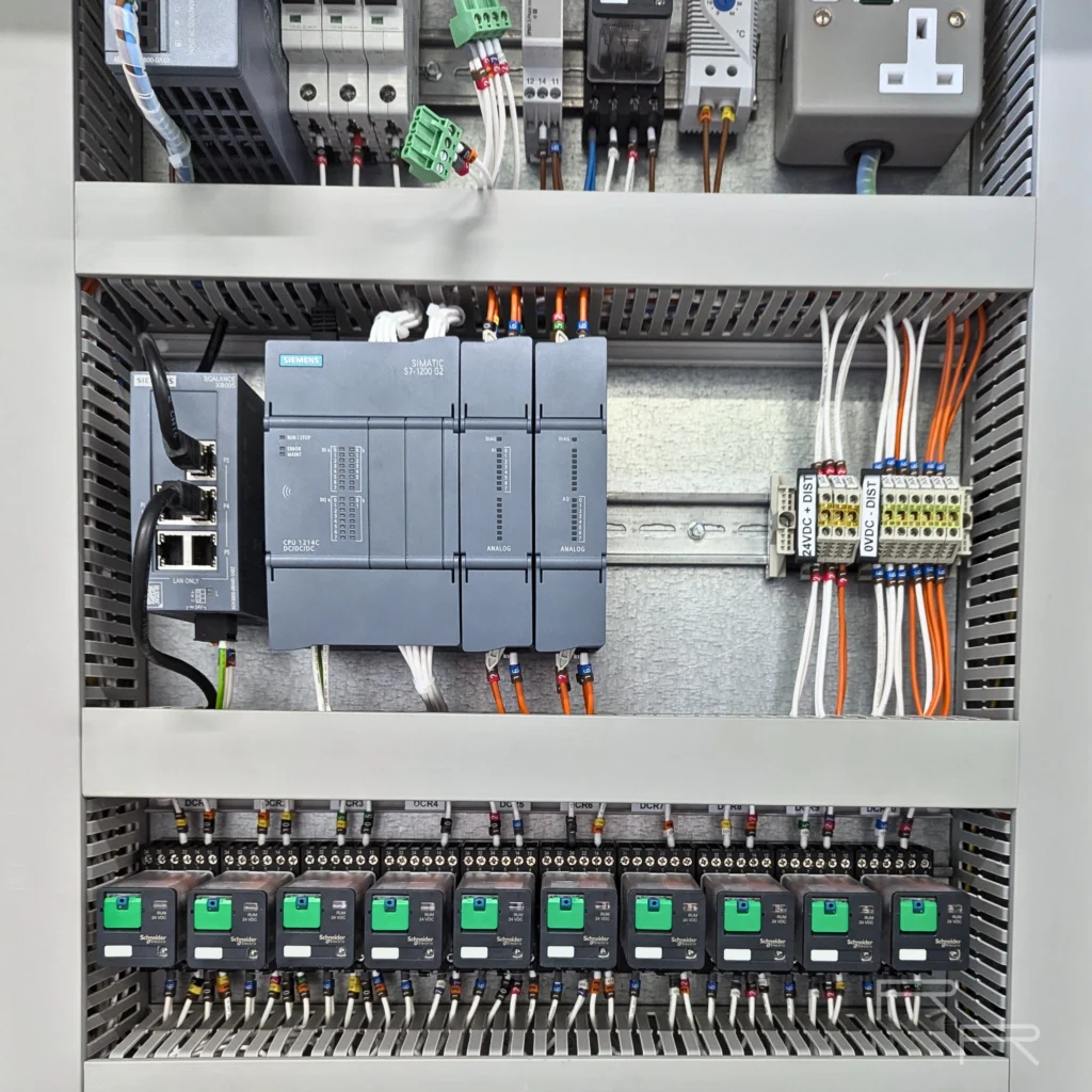 Siemens SIMATIC S7-1200 PLC with analogue modules, a Scalance Ethernet switch and a bank of Schneider 24VDC output relays